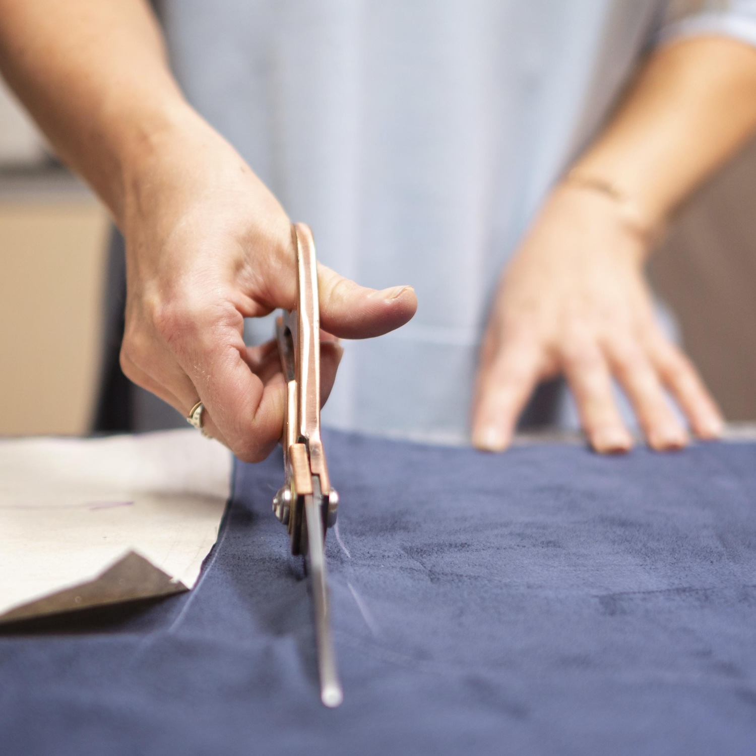 close-up-hand-cutting-material
